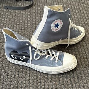 Gray Comme des Garcons Converse high-tops.